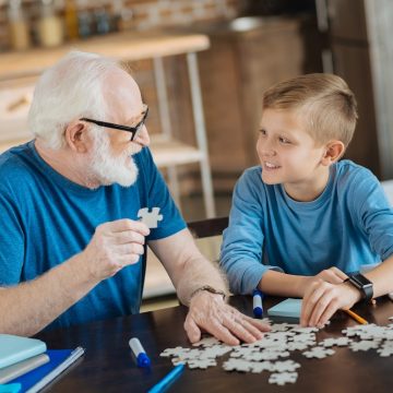 Elderly man with boy puzzle LR